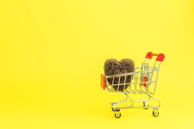 Shopping trolley with heart shaped cookies with copy space