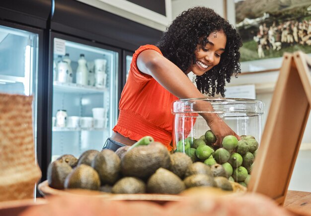 Shopping vegetables and customer in grocery store for healthy food vegan choice and excited fruits sales or discount promotion Retail commerce and happy woman in store with green food groceries