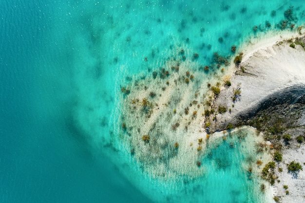 The shores of the mountain lake, the blue water in the lake. Aerial view, from top to bottom