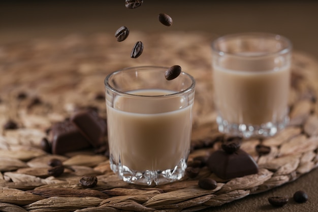 Short glasses of Irish cream Liquor or Coffee Liqueur with chocolate and coffee beans. Winter holiday decorations