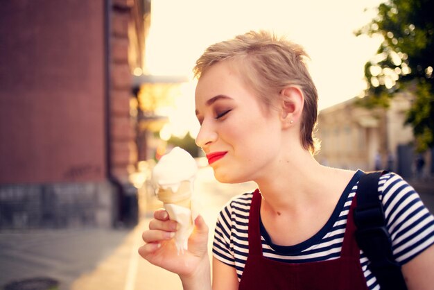 Short haired woman outdoors eating ice cream walk lifestyle