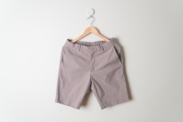 short pants hanging with wood hanger on wall