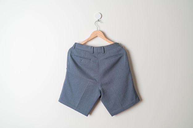 short pants hanging with wood hanger on wall