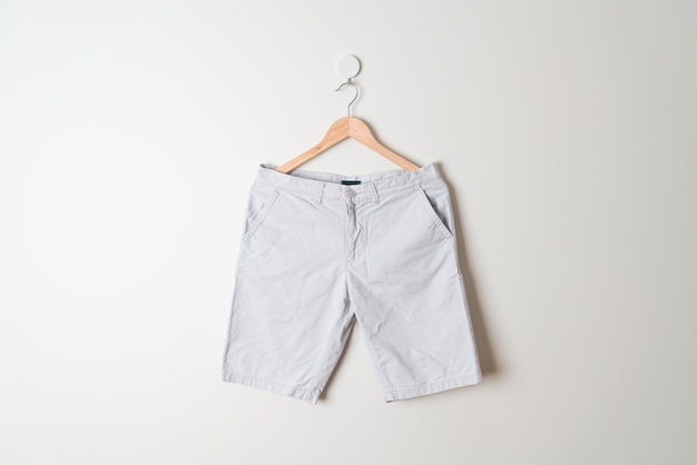 short pants hanging with wood hanger on wall