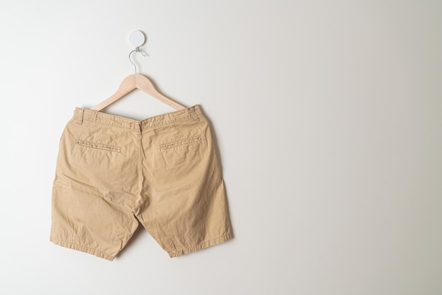 short pants hanging with wood hanger on wall