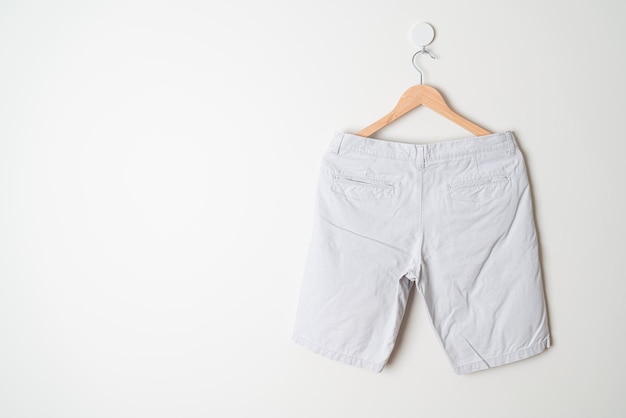 short pants hanging with wood hanger on wall