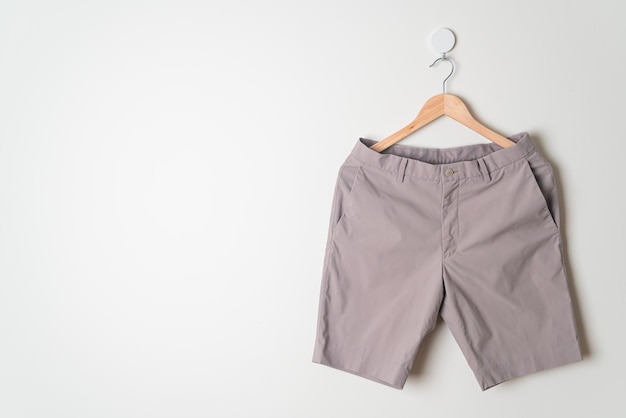 short pants hanging with wood hanger on wall