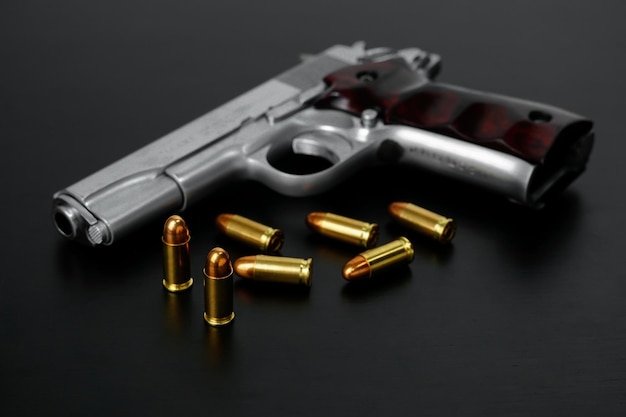 Short pistol and ammunition Put on a black background pistol with ammo