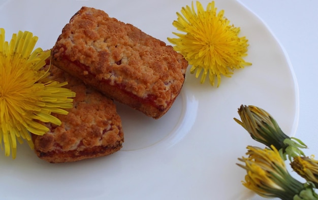 Shortbread rectangular biscuits with jam with dandelion tea