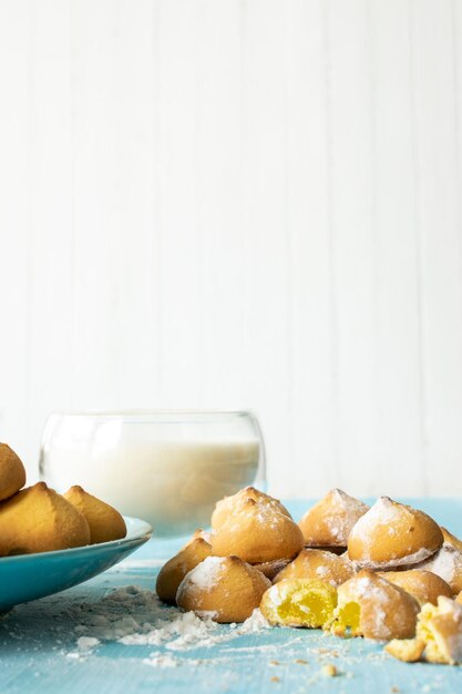 Shortbread with
jam filling view of baked sweet biscuits and a glass of milk
selective focus