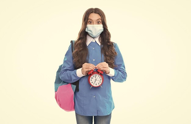 Photo shortened quarantine period surprised kid hold alarm clock coronavirus incubation period