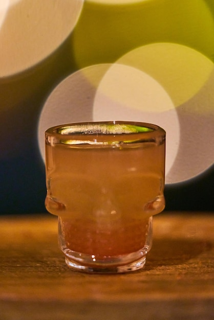 Shot of alcoholic beverage in a skull shaped glass mixology concept