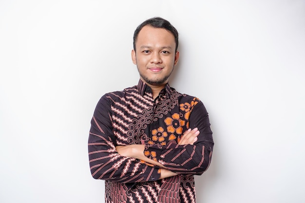 Shot of a Asian young confident man posing with crossed arm against a white background