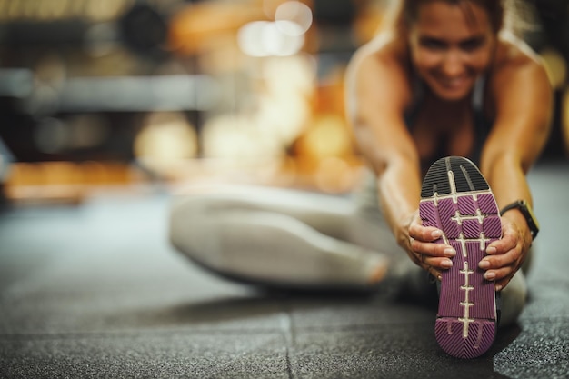 Photo shot of an attractive young woman doing stretching exercises at the gym.