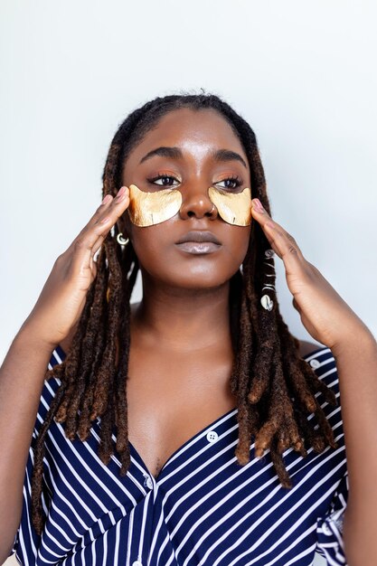 Shot of a beautiful African woman wearing undereye gel patches as part of her beauty regime