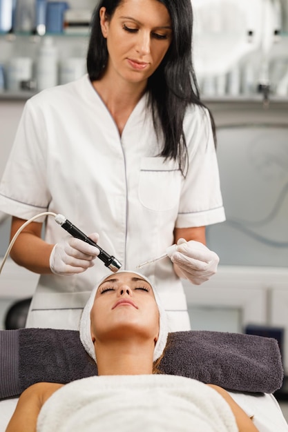 Shot of a beautiful young woman on a facial mesotherapy non needle treatment at the beauty salon.