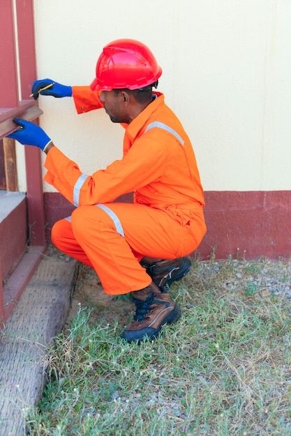 Shot of an Black man taking measurement outside the home