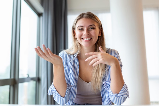 Shot of a businesswoman on a video call while sitting at her deskCropped shot of an attractive young woman using her laptop to make a video call at home