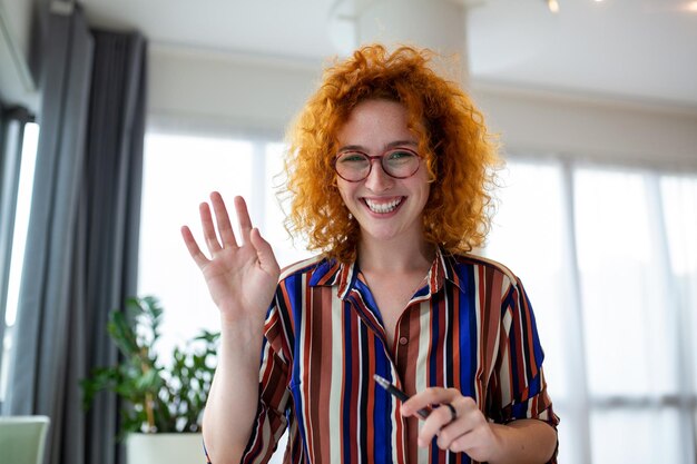 Shot of a businesswoman on a video call while sitting at her\
deskcropped shot of an attractive young woman using her laptop to\
make a video call at home