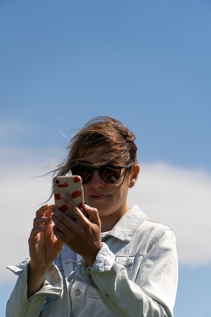 Shot of a Caucasian woman from Ireland checking her phone