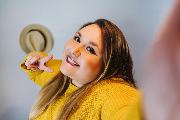 Photo shot of a caucasian woman smiling and taking selfie