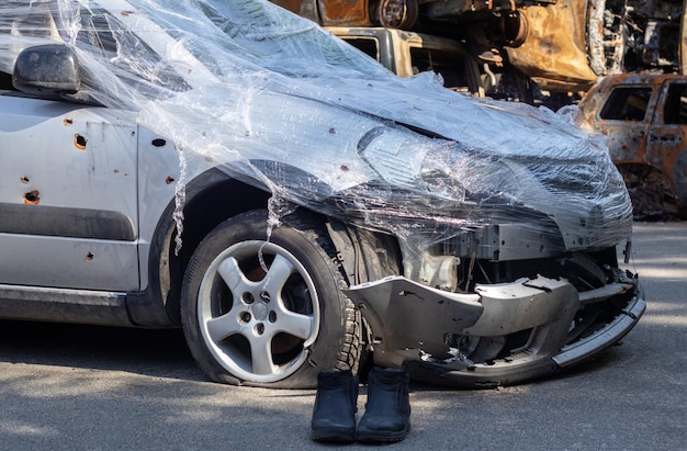 Shot damaged cars during the war in ukraine the vehicle of\
civilians affected by the hands