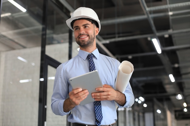 Photo shot of a engineer using a digital tablet on a construction site.