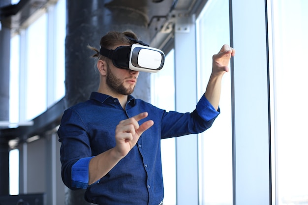 Shot of an engineer wearing a VR headset in an new building. Change the way you see and experience the world.