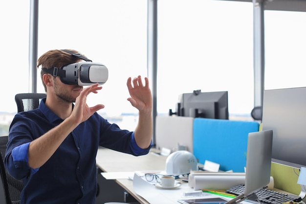 Shot of an engineer wearing a VR headset in an new building. Change the way you see and experience the world.