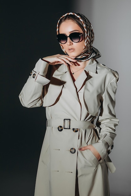 shot of fashionable woman in trench coat