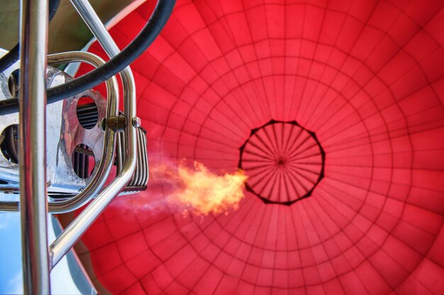 赤い熱気球の点火バーナーを下から撮影