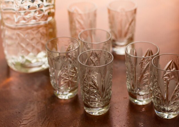 Shot glasses of vodka on a wooden table addiction to alcohol