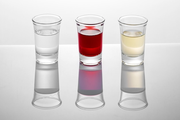 Shot glasses on white background