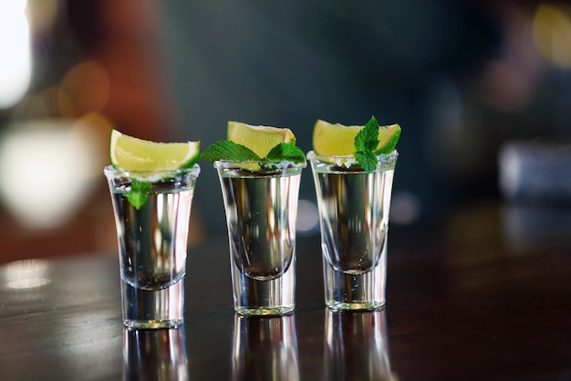 Shot glasses with tequila on bar counter