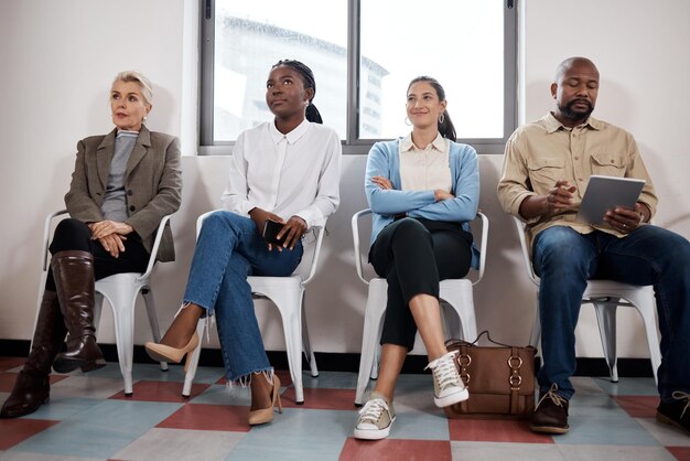 Photo shot of a group of businesspeople waiting in a line in a modern office