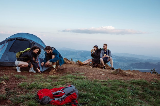 Shot of a group of friends camping in mountains