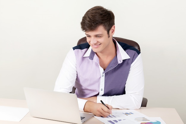 Shot of a handsome creative director businessman working in the office while sitting at desk with laptop.