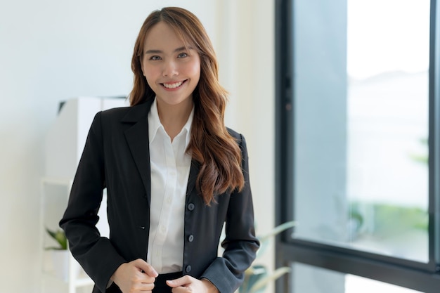 Shot of happy young asian woman looking at camera Attractive businesswoman