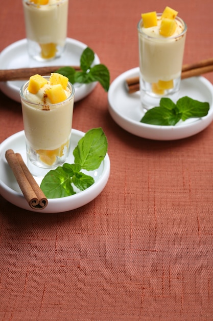 Shot mango sorbet with cinnamon, dessert for catering of a celebration.