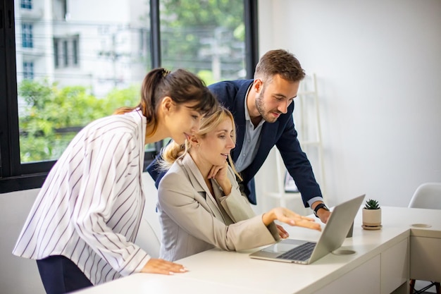 Shot of a mature businesswoman sitting and training her team in the office