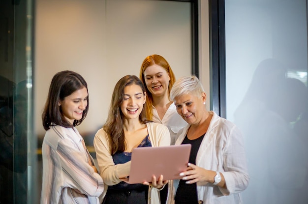 Shot of a mature businesswoman sitting and training her team in the office