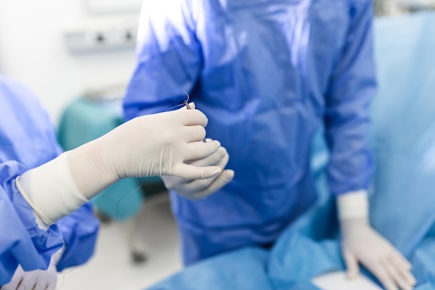 Shot in the Operating Room Assistant Hands out Instruments to Surgeons During Operation Surgeons Perform Operation Professional Medical Doctors Performing Surgery