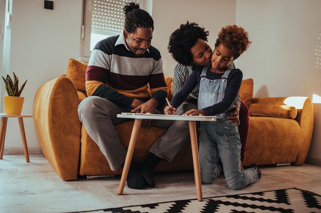 Photo shot of parents and kid painting pictures at home