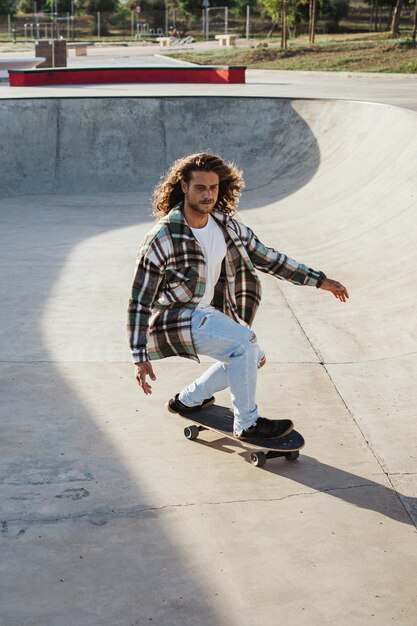 Shot of professional skater riding a skateboard in a concrete pool