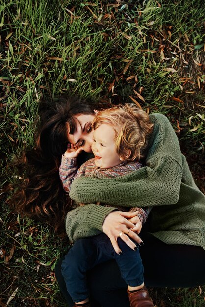 Shot of a single mother spending some time at the park with her son