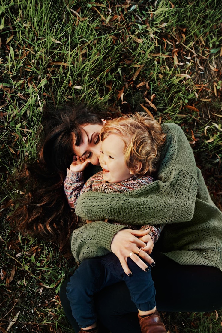 Photo shot of a single mother spending some time at the park with her son