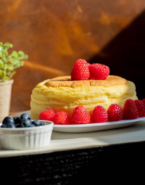 Shot of small cake with berries and blurred background