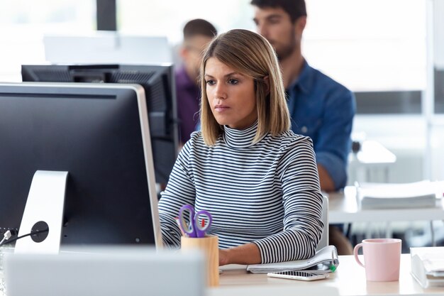 Shot of software developer working with computer in the modern startup office.