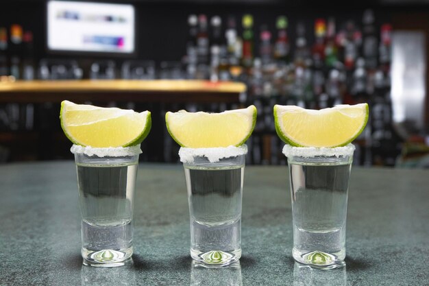 A shot of tequila with salt and lime Tequila on the background of a Mexican beach Golden Mexican Tequila Copy space