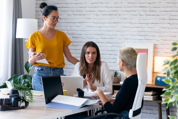 Shot of three modern female entrepreneurs who talk about new ideas for to next work in a joint workspace.